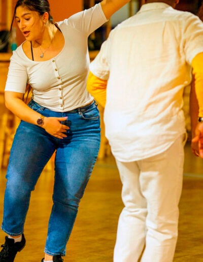 Eine Frau von vorne und ein Mann von hinten tanzen Salsa beim Salsa-Tanzkurse in Ulm in der Tanzschule Ritmo Latino@